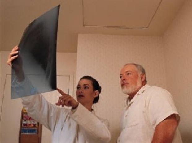 female doctor showing xray to male patient